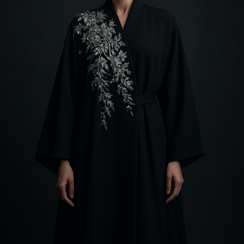 The Platinum Night Bloom Abaya
Tone: Midnight black or midnight grey
Design:
Asymmetric platinum floral embroidery concentrated on one shoulder.
Embellishment:
Platinum crystals giving a cool, expensive shimmer.
Vibe: Cold luxury, bold and unforgettable.