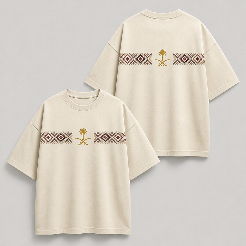 Create a premium oversized unisex T-shirt mockup in a warm cream/off-white color. Add a horizontal Saudi-inspired geometric woven pattern across the upper chest, split into two equal sections with a gold Saudi emblem (palm tree and crossed swords) perfectly centered between them. Repeat the exact same design on the upper back with identical placement and proportions. The pattern should feature traditional Saudi tribal motifs in burgundy, dark brown, taupe, and beige with a refined woven appearance. Keep the design minimal, elegant, luxurious, and perfectly symmetrical. Use a heavyweight cotton oversized fit with a clean crew neck, soft studio lighting, and a realistic apparel mockup. No additional graphics, text, or distress effects. Premium streetwear aesthetic.
edit the attached fashion design with these instructions: Create a premium oversized unisex T-shirt mockup in a warm cream/off-white color. Add a horizontal Saudi-inspired geometric woven pattern across the upper chest, split into two equal sections with a gold Saudi emblem (palm tree and crossed swords) perfectly centered between them. Repeat the exact same design on the upper back with identical placement and proportions. The pattern should feature traditional Saudi tribal motifs in burgundy, dark brown, taupe, and beige with a refined woven appearance. Keep the design minimal, elegant, luxurious, and perfectly symmetrical. Use a heavyweight cotton oversized fit with a clean crew neck, soft studio lighting, and a realistic apparel mockup. No additional graphics, text, or distress effects. Premium streetwear aesthetic.. keep it photorealistic, just the design no text