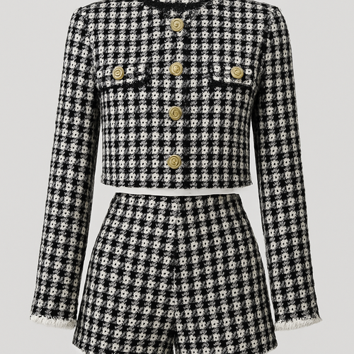 Tweed crop jacket in black and white with matching tweed shorts
Jacket slightly longer gold buttons pockets on breasts full length sleeves slight white fringe on end of sleeves