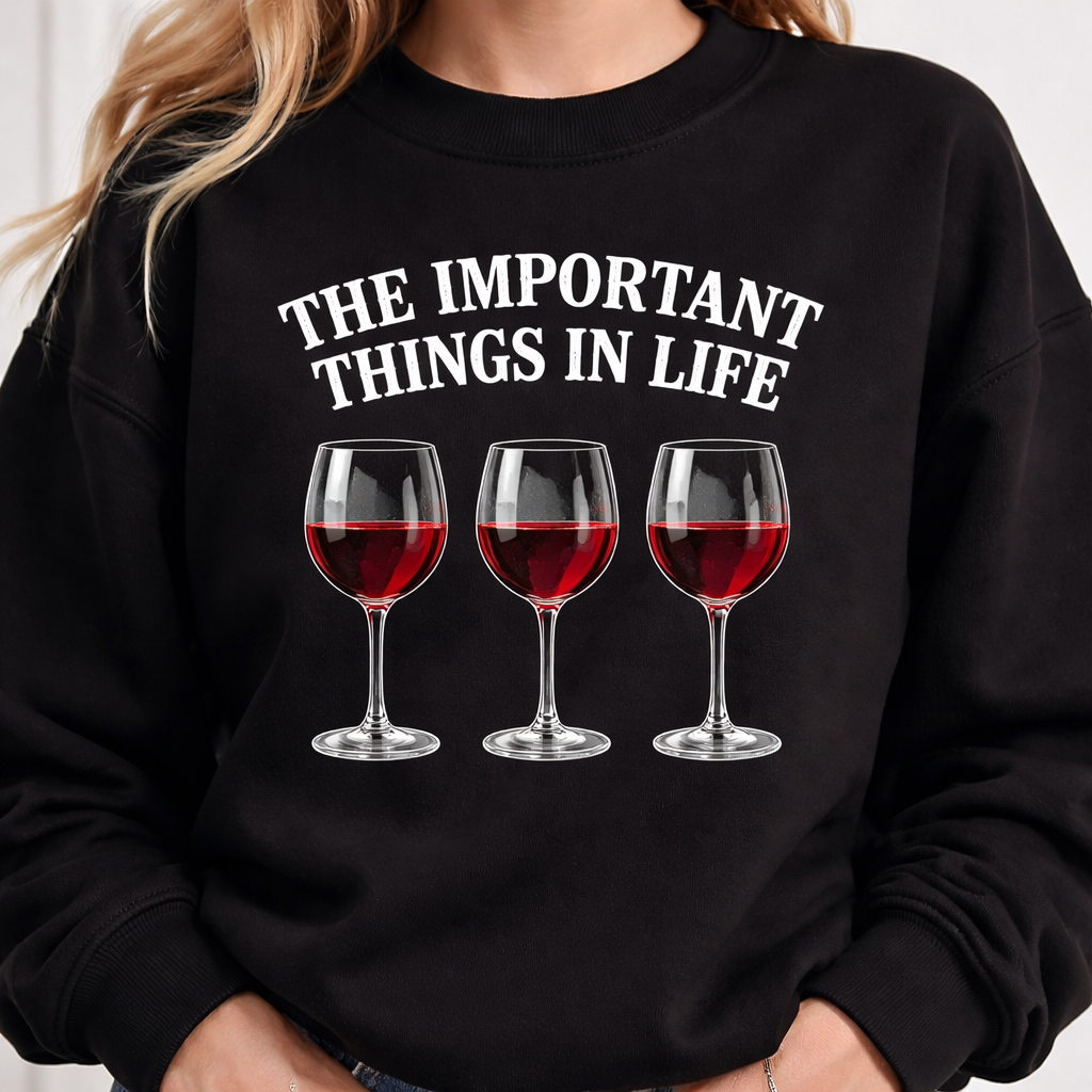 A black jumper with writing on the front the says” the important things in life “ then underneath that is three wine glasses in the glasses is all red wine
A black jumper with writing on the front the says” the important things in life “ then underneath that is three wine glasses in the glasses is all red wine