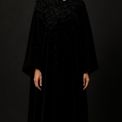 The Velvet Midnight Bloom Abaya
Tone: Deep velvet black
Fabric: Heavy velvet–crepe blend
Design:
A dense cluster of 3D velvet flowers around the neckline flowing softly across one sleeve.
Embellishment:
Black Swarovski stones scattered like stars.
Vibe:
Royal, powerful, and irresistibly classy.