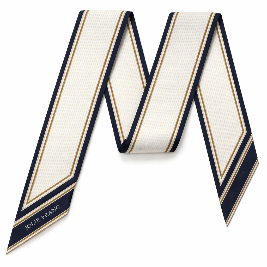 Design a 5cm x 86cm silk twill scarf for a luxury French brand called Jolie Franc. The design is classic, timeless, and tailored. Feature a precise double-line frame running the length of the scarf. Interior pattern should be architectural micro-stripes inspired by fine suiting. Color palette: ivory base with inky navy and muted antique gold accents. Hand-rolled edges. Minimal, structured, elegant, and instantly recognizable when wrapped around a Kelly-style bag handle or worn for evening.
Design a 5cm x 86cm silk twill scarf for a luxury French brand called Jolie Franc. The design is classic, timeless, and tailored. Feature a precise double-line frame running the length of the scarf. Interior pattern should be architectural micro-stripes inspired by fine suiting. Color palette: ivory base with inky navy and muted antique gold accents. Hand-rolled edges. Minimal, structured, elegant, and instantly recognizable when wrapped around a Kelly-style bag handle or worn for evening., classic style, show front and back
