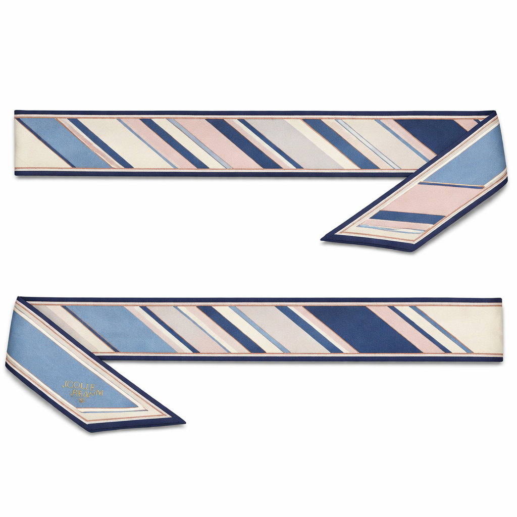 Design a 5cm x 86cm silk twill scarf for a luxury brand called Jolie Franc inspired by classic American Ivy League style with a slightly more feminine refinement, similar to a softened J.Press aesthetic. Feature a narrow ribbon stripe motif with clean, evenly spaced stripes and gentle tonal variation. Use a timeless, all-season color palette of warm ivory, soft navy, faded cornflower blue, and muted blush or dusty rose accents. Keep the design structured yet light, with a thin framed border and hand-rolled edges. The overall feel should be polished, understated, feminine without being romantic, and instantly recognizable when wrapped around a Kelly-style bag handle or worn for effortless day-to-evening style.
Design a 5cm x 86cm silk twill scarf for a luxury brand called Jolie Franc inspired by classic American Ivy League style with a slightly more feminine refinement, similar to a softened J.Press aesthetic. Feature a narrow ribbon stripe motif with clean, evenly spaced stripes and gentle tonal variation. Use a timeless, all-season color palette of warm ivory, soft navy, faded cornflower blue, and muted blush or dusty rose accents. Keep the design structured yet light, with a thin framed border and hand-rolled edges. The overall feel should be polished, understated, feminine without being romantic, and instantly recognizable when wrapped around a Kelly-style bag handle or worn for effortless day-to-evening style., classic style, show front and back