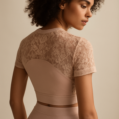 Luxury nude pink lace sportswear outfit, combining soft technical fabric and high-end lace transparency on shoulders and back. Delicate, feminine, yet functional. Premium studio editorial, soft light, focus on texture transitions, ultra-detailed materials, elegant athletic woman with natural curly hair, Lauren Secret fashion campaign.