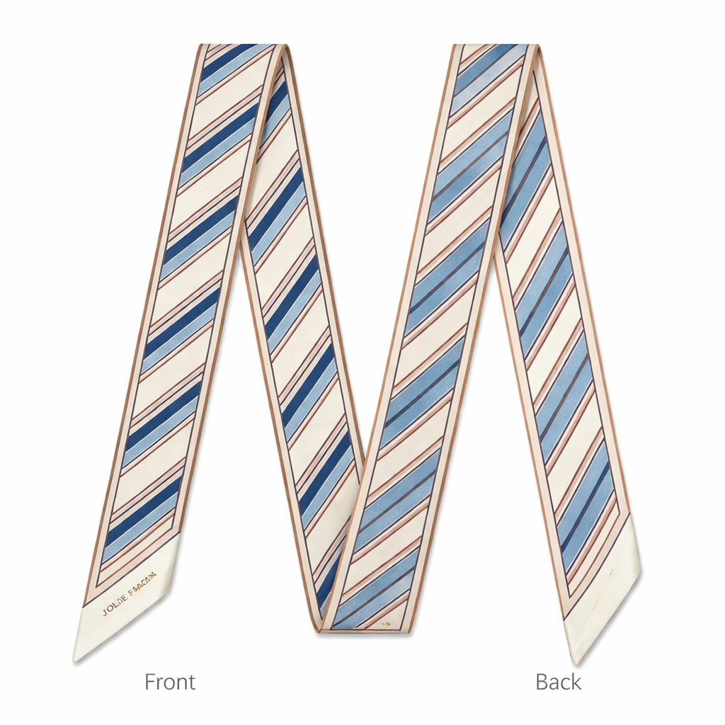 Design a 5cm x 86cm silk twill scarf for a luxury brand called Jolie Franc inspired by classic American Ivy League style with a slightly more feminine refinement, similar to a softened J.Press aesthetic. Feature a narrow ribbon stripe motif with clean, evenly spaced stripes and gentle tonal variation. Use a timeless, all-season color palette of warm ivory, soft navy, faded cornflower blue, and muted blush or dusty rose accents. Keep the design structured yet light, with a thin framed border and hand-rolled edges. The overall feel should be polished, understated, feminine without being romantic, and instantly recognizable when wrapped around a Kelly-style bag handle or worn for effortless day-to-evening style.
Design a 5cm x 86cm silk twill scarf for a luxury brand called Jolie Franc inspired by classic American Ivy League style with a slightly more feminine refinement, similar to a softened J.Press aesthetic. Feature a narrow ribbon stripe motif with clean, evenly spaced stripes and gentle tonal variation. Use a timeless, all-season color palette of warm ivory, soft navy, faded cornflower blue, and muted blush or dusty rose accents. Keep the design structured yet light, with a thin framed border and hand-rolled edges. The overall feel should be polished, understated, feminine without being romantic, and instantly recognizable when wrapped around a Kelly-style bag handle or worn for effortless day-to-evening style., classic style, show front and back